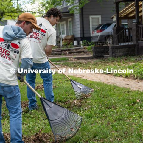Delta Phi Fraternity members Quinny Brumbaugh and Dominik Kluthe rake leaves in a homeowner’s front lawn during the Big Event. May 4, 2024. Photo by Kirk Rangel for University Communication.